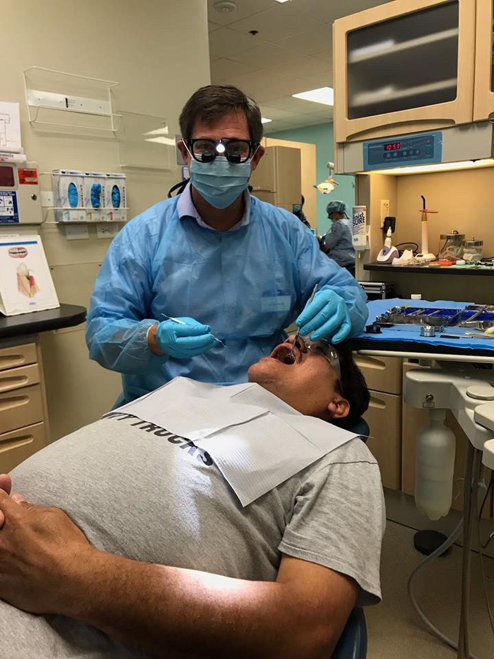 Dr. Westerberg performing a routine dental exam and cleaning. Ivy Lane Dentistry offers teeth cleaning services in San Antonio, TX. 