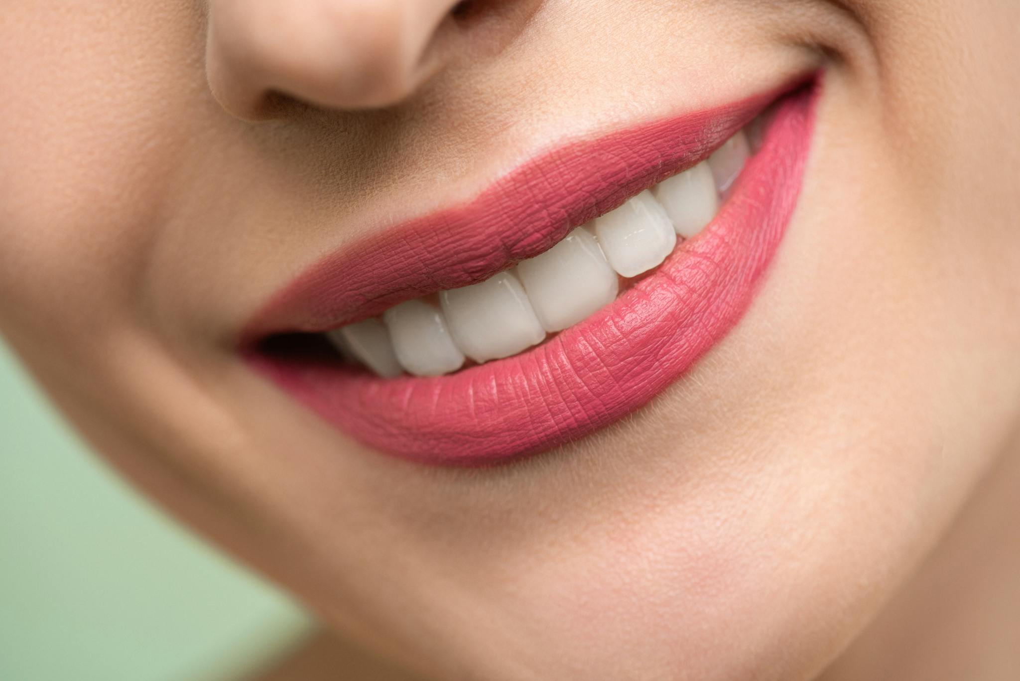 Woman With Red Lipstick Smiling. Ivy Lane Dentistry offers dental sealant services in San Antonio, TX.