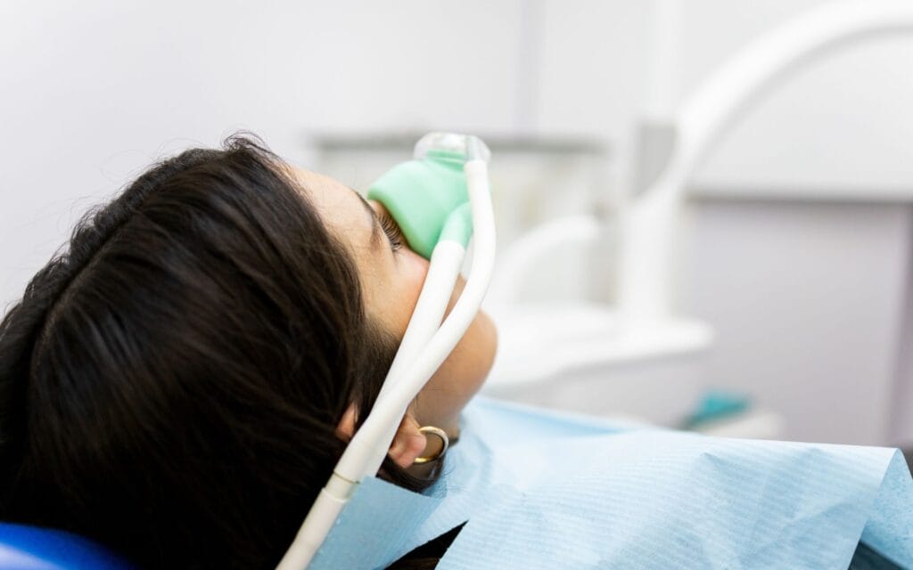 a dark haired woman undergoing sedation dentistry